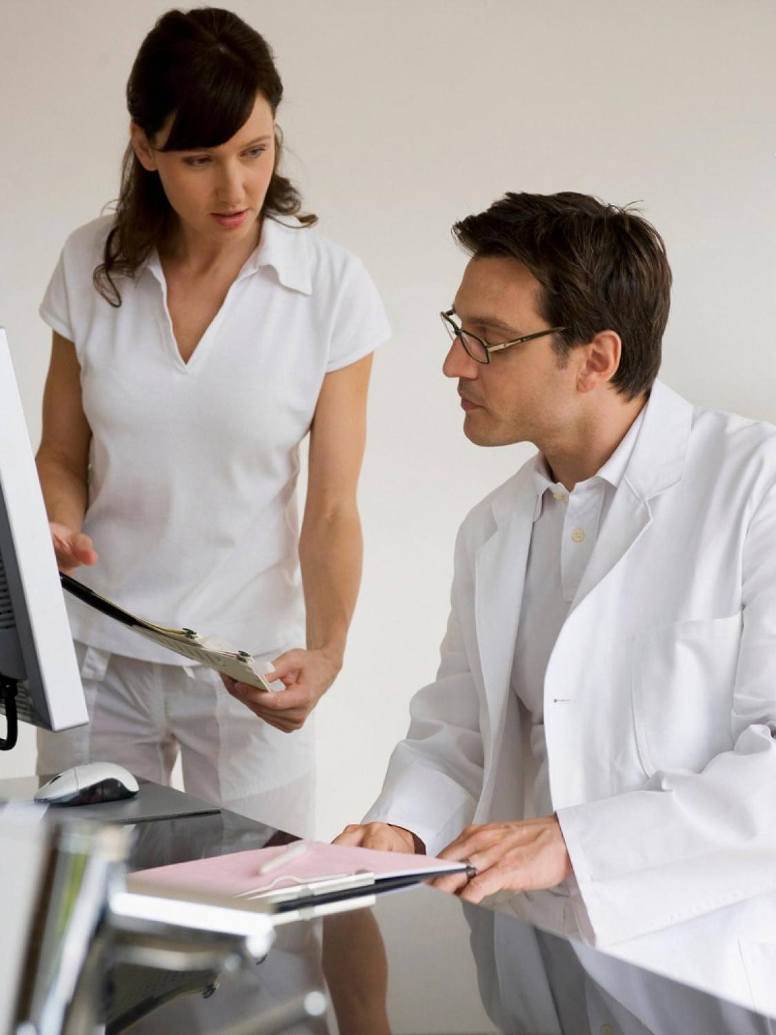 Doctor and colleague reviewing patient notes together in a UAE clinic